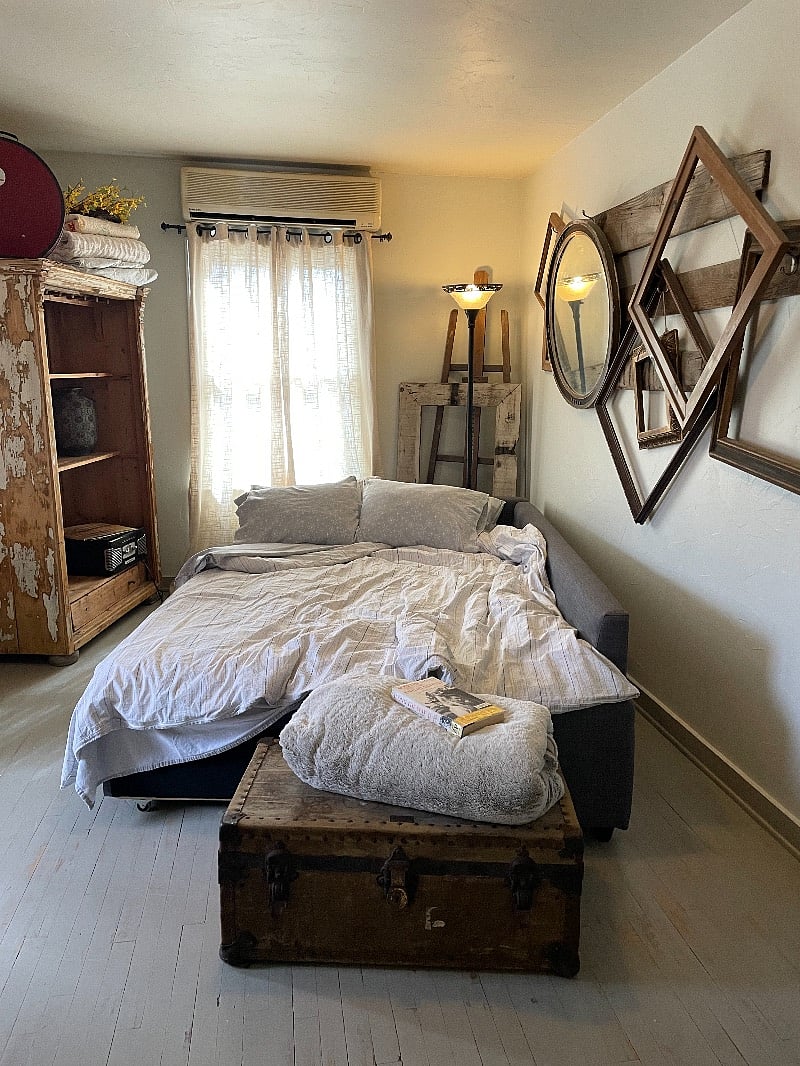 queen size couch in living room, window views of city lights, AC
