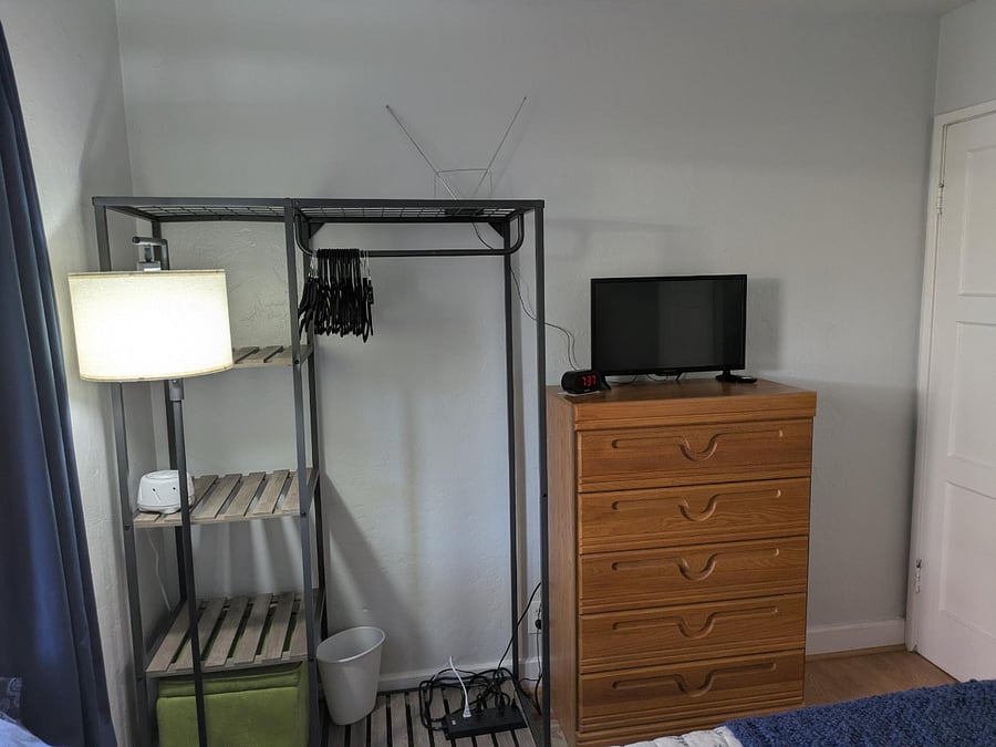 smart TV, dresser, clothes rack