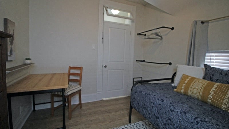 Open closet system in second bedroom.