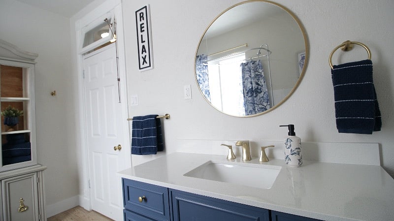 Updated bath with gold fixtures.