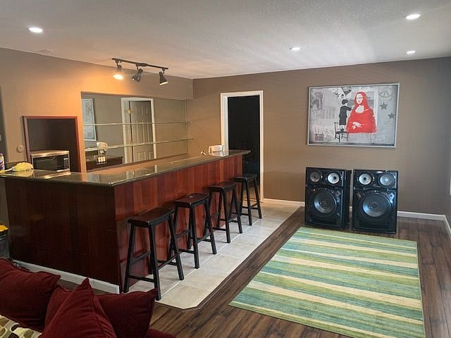 Full size sink, induction cooktop, convention countertop oven, microwave, multiple fridge and freezer