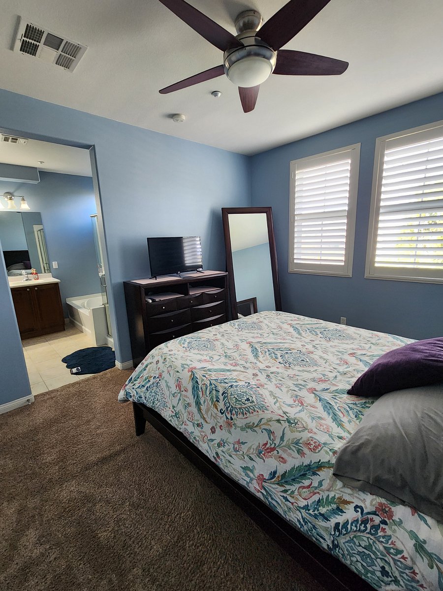 spacious primary bedroom with queen bed and smart tv. lots of sunlight! 