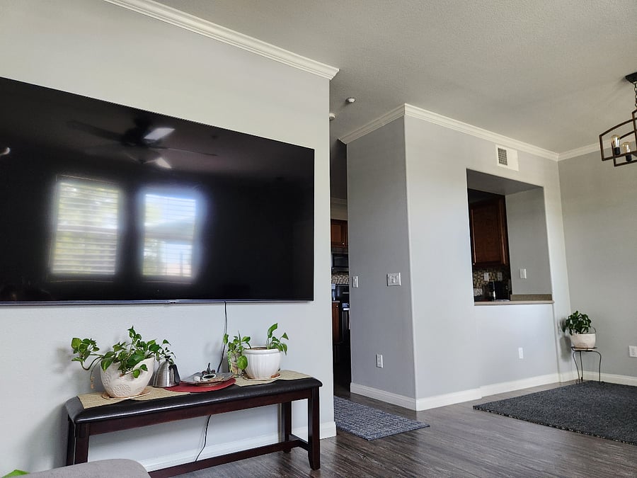 90" smart tv taken from the couch, kitchen pass through on the right (and dining area)