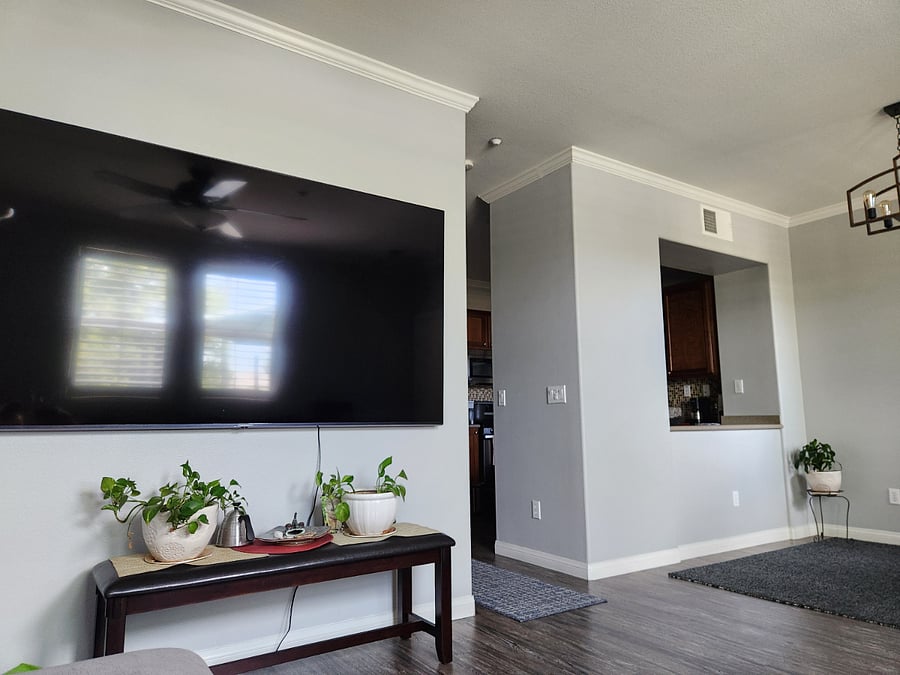 90" smart tv from couch; kitchen pass through on right