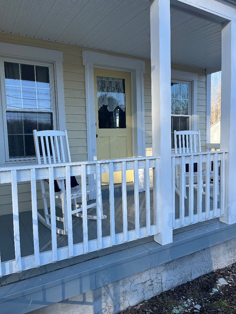 Picturesque rocking chairs on private covered porch off of the living room