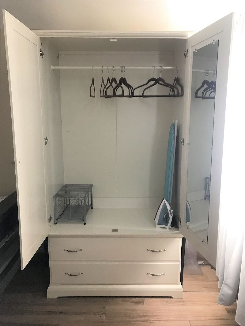 Closet with a mirror that reflects you from head to toe.