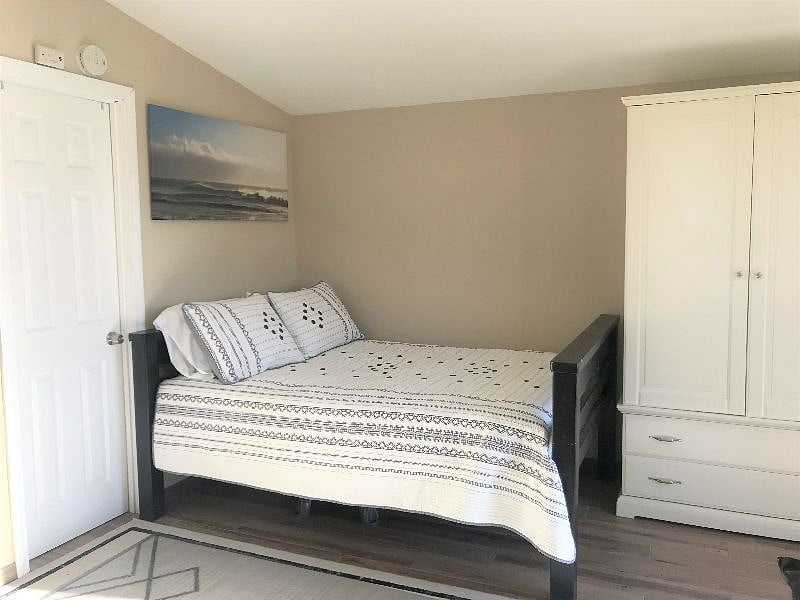 Full Size platform bed with room for luggage or more underneath.