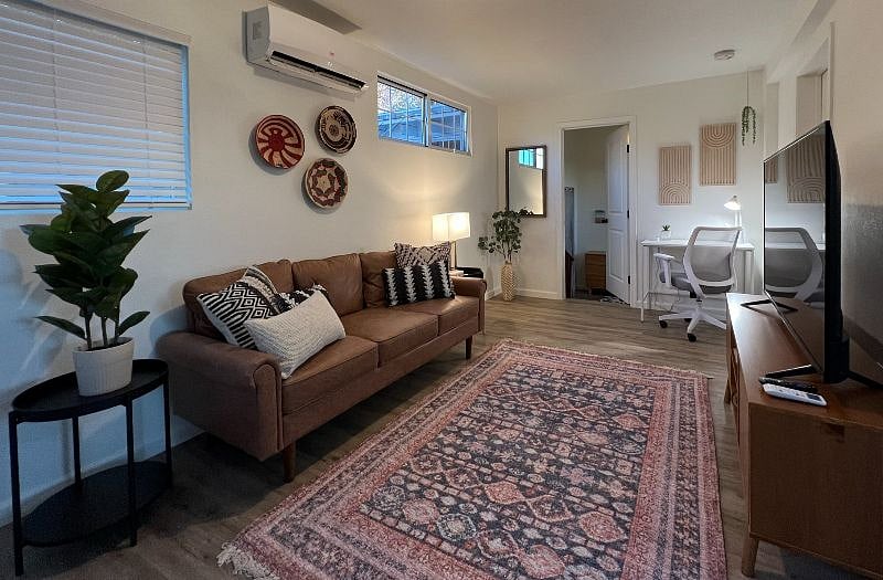 Living Room with Smart TV for easy streaming, cozy couch, throw pillows and throw blanket