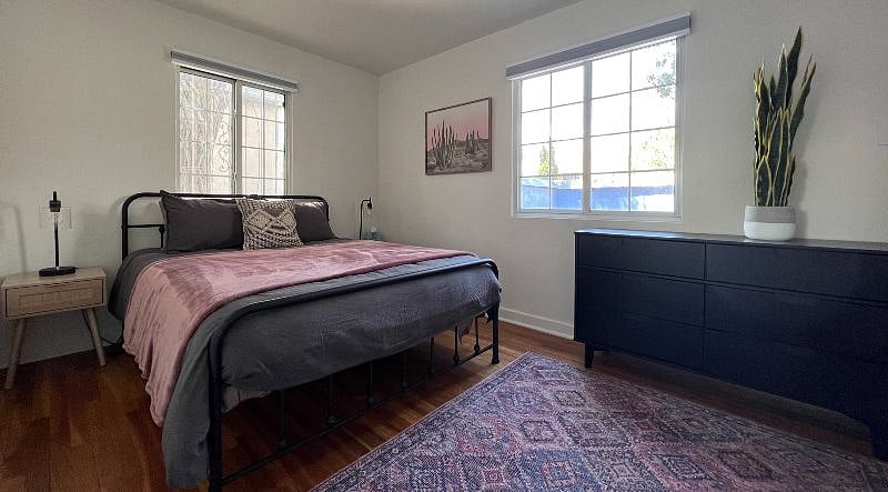 QUEEN BEDROOM with large closet, dresser, Quality Linens, New Quality Mattress, Great Natural Light and Room Darkening Window Treatments for a great night's sleep!  Private Enclosed Patio off Bedroom!