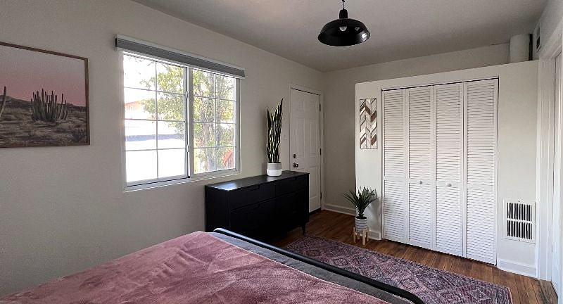 QUEEN BEDROOM with large closet, dresser, Quality Linens, New Quality Mattress, Great Natural Light and Room Darkening Window Treatments for a great night's sleep!  Private Enclosed Patio off Bedroom!