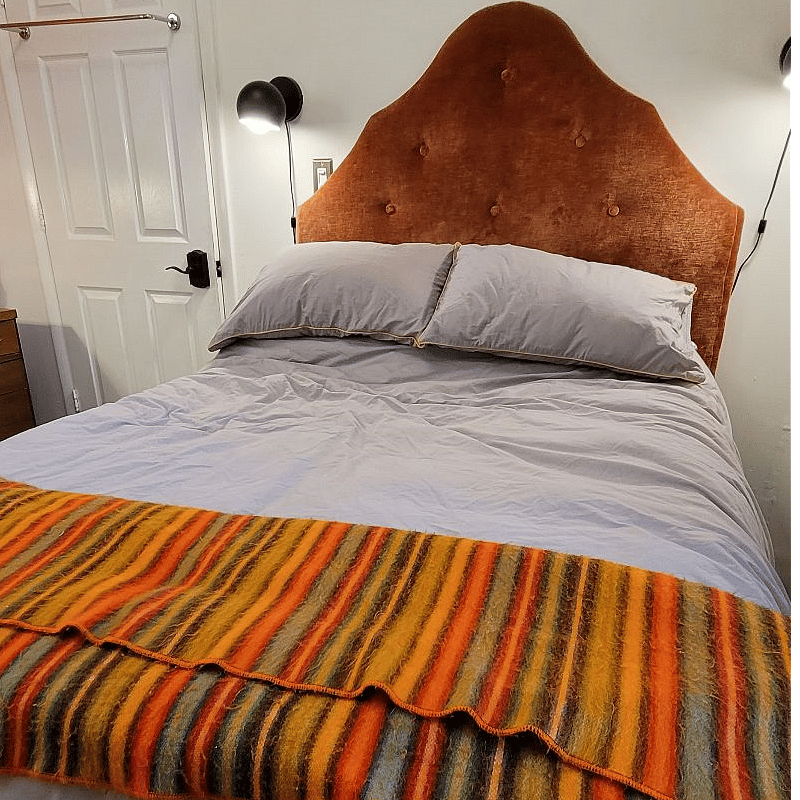 Full size bed with memory foam mattress, several sets of linens, room for storage underneath.