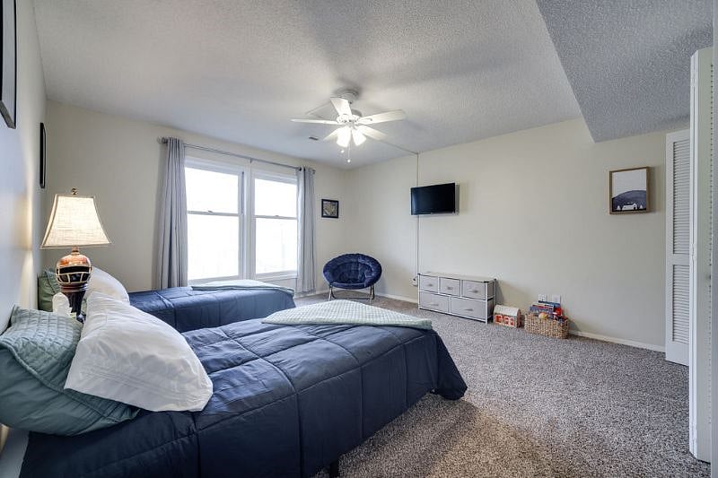 Large bedroom, blackout curtains, Roku TV, and generous closet space.