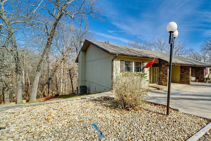 View from the side of the townhome - an end unit! Beautiful setting backed up to the tree line. The street is not a through street, so it's very quiet.