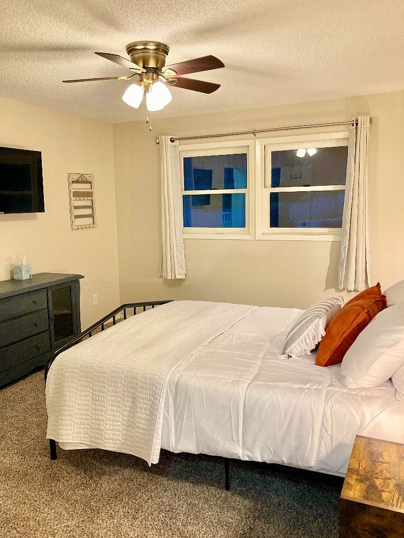 Another photo of the upstairs bedroom. Each bedroom has blackout curtains and a ceiling fan.