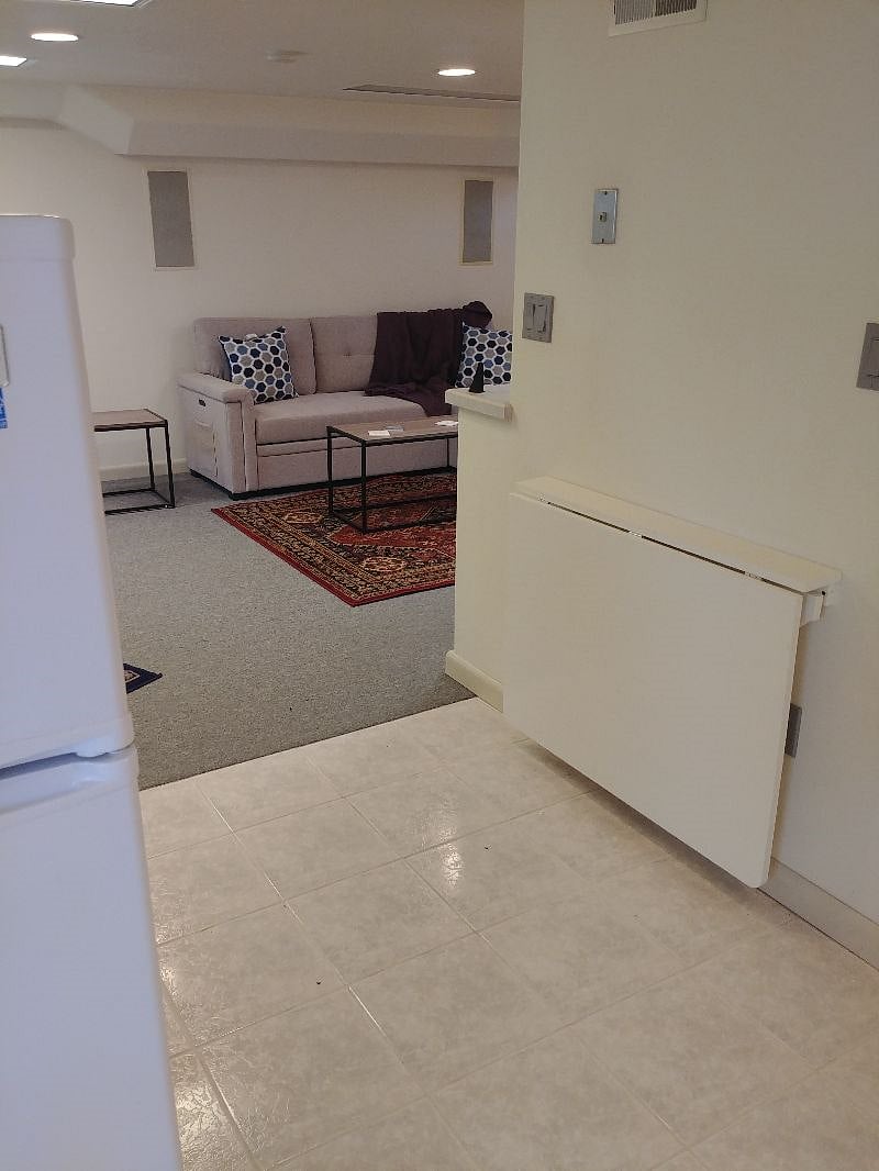 Kitchenette seating. It can be folded up to create extra space if wanted. Chairs are stored in the closet. View toward the living room.