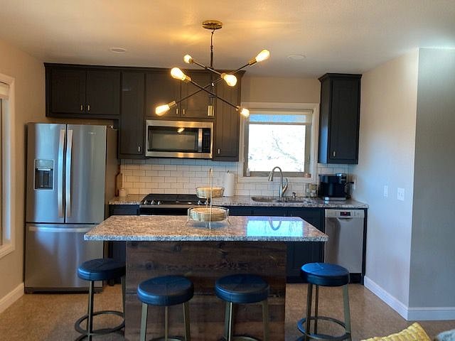 Kitchen stocked with all the necessities for meal prep. Full size fridge, full size range and small dishwasher