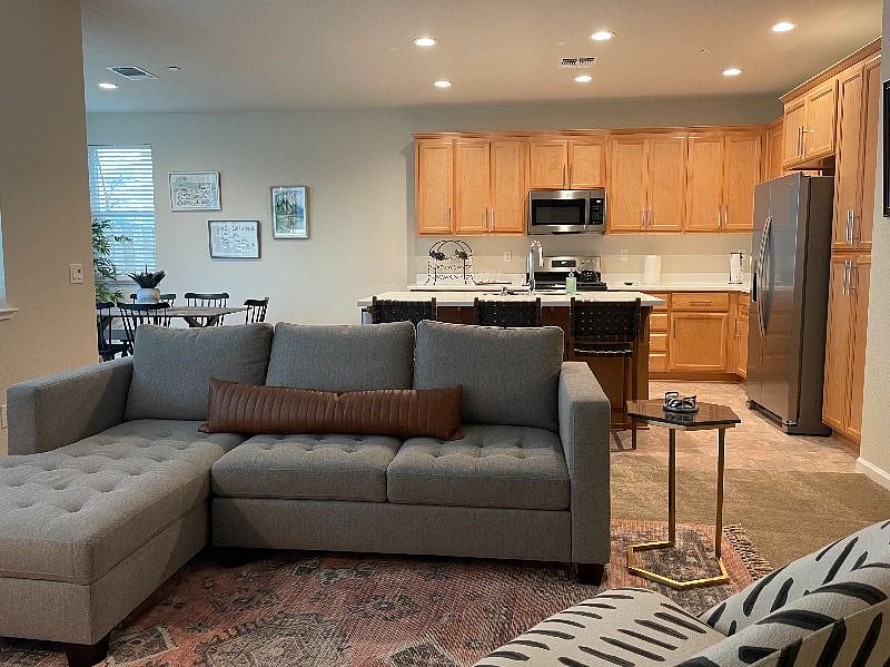 Living room is located next to the kitchen and dining area.