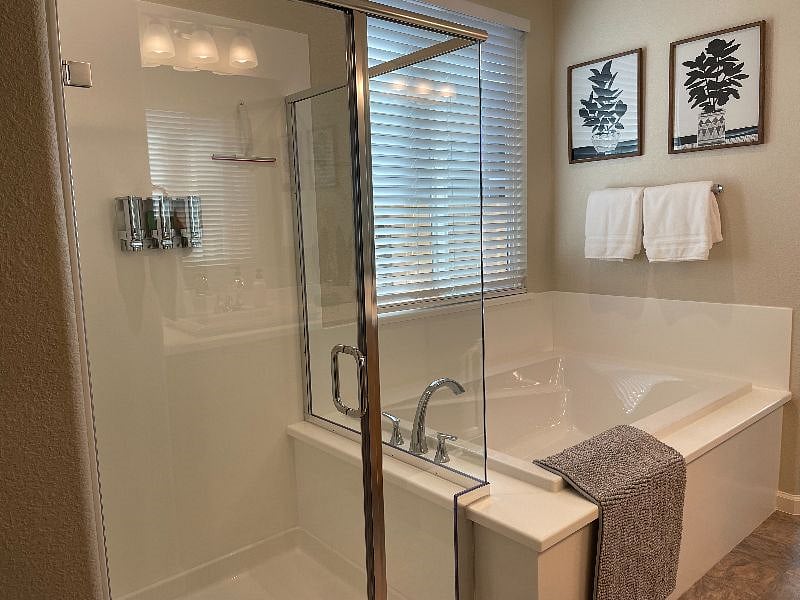 Walk-in-shower and large tub in master bathroom.