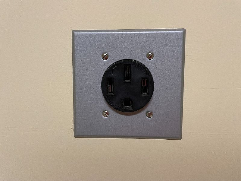 Electric car charger located in the garage.