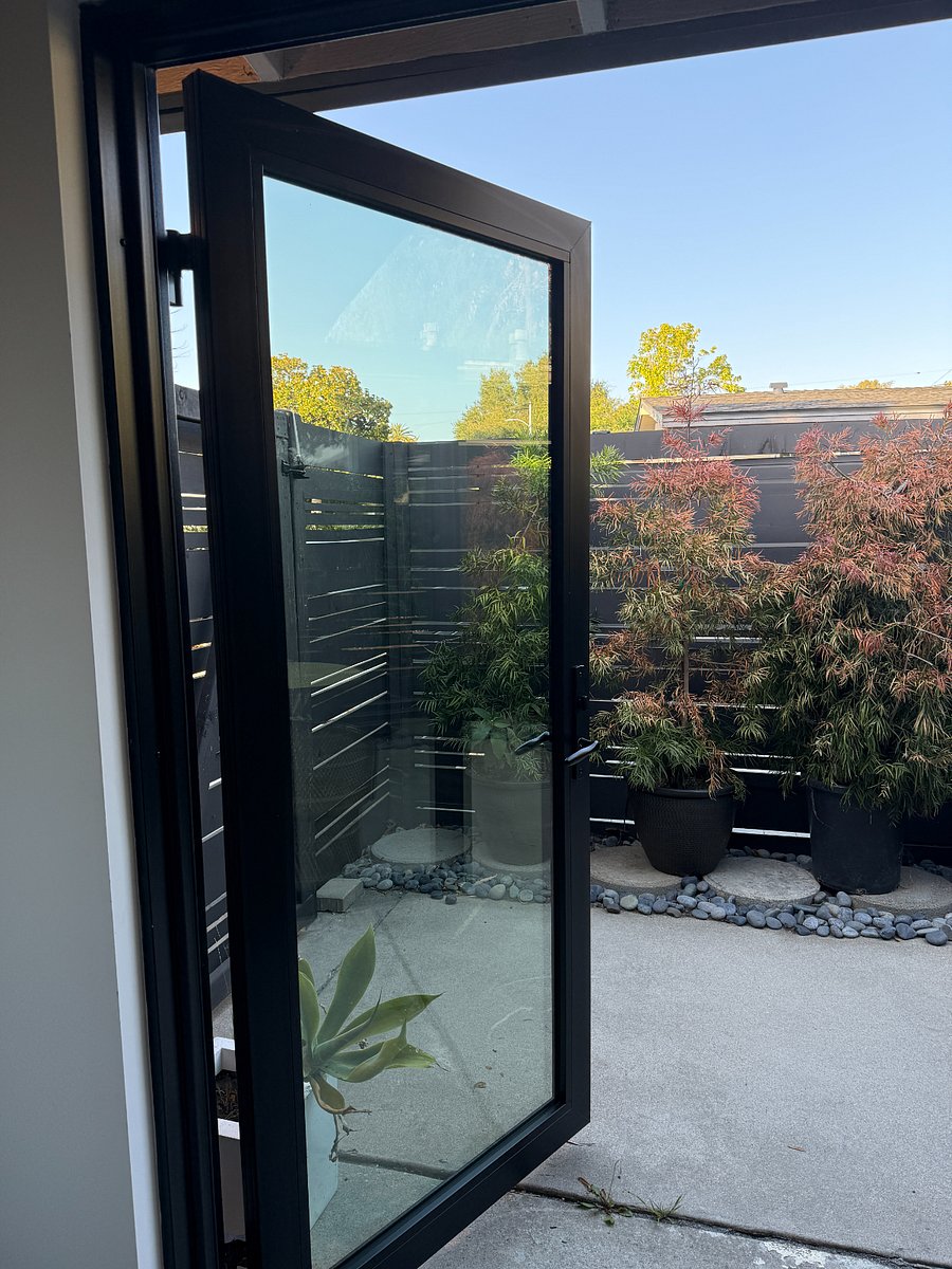 glass french doors open to privet patio