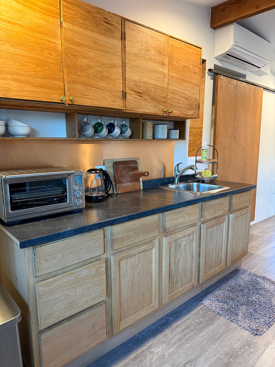 air fryer, coffee maker, electric tea, hot plate, electric fry pan microwave, refrigerator, garbage disposal . mixing bowles, tea cups plates bowls and silverware.