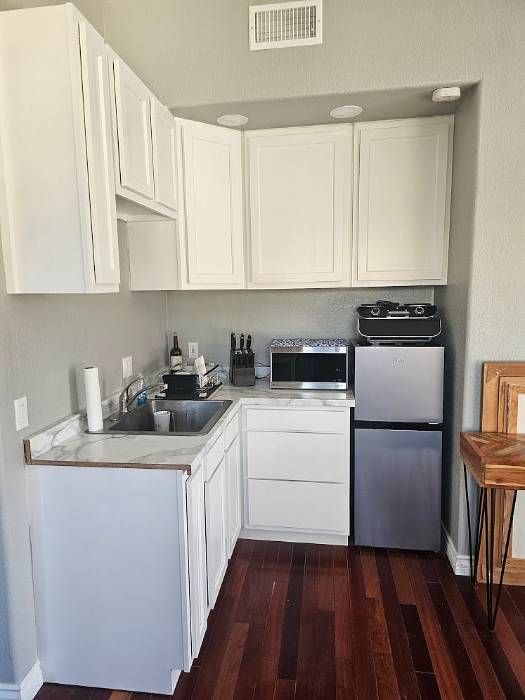 efficiency Kitchen stocked with cutlery, pots and pans, keuric coffee maker