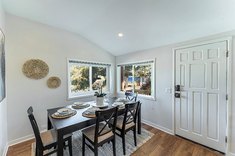 The dining room easily seats 6, with 4 chairs and a bench. There are ocean views from the dining room as well.