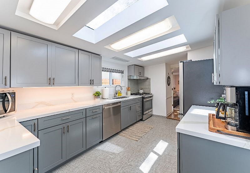 The kitchen has been updated and has all of the modernized amenities. Skylights help to keep it sunny and bright.