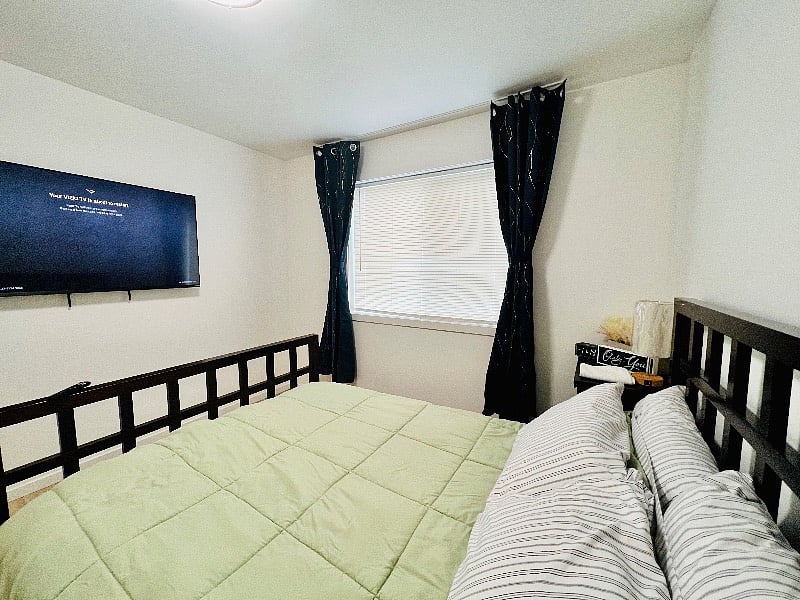 Primary bedroom with light blocking curtains, 4K 55 smart TV