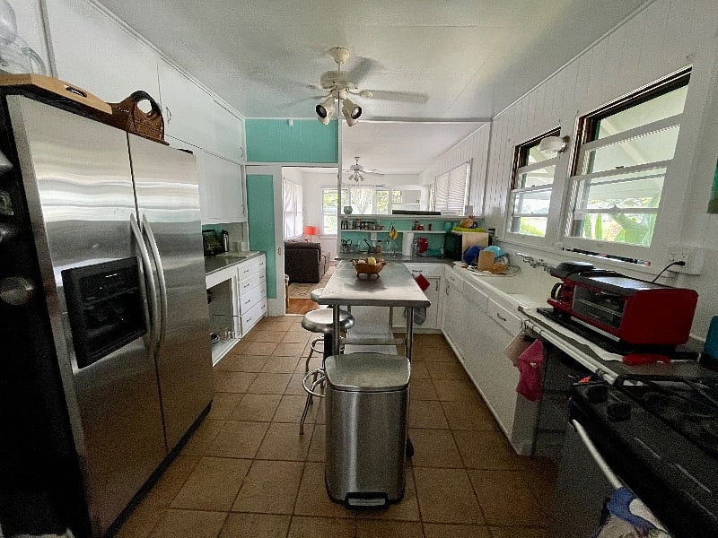 Kitchen, gas stove, microwave, side by side frig. Picture taken in kitchen looking out toward living room.