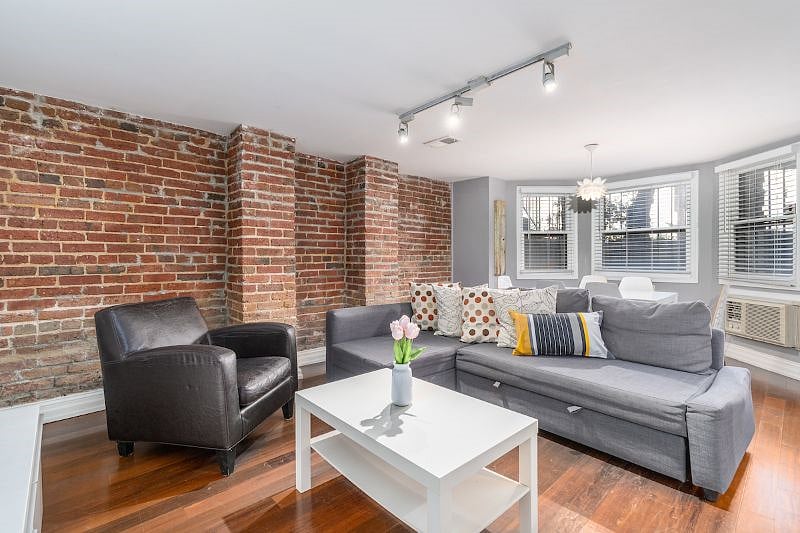 living room with sofa and armchair