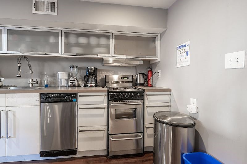 kitchen with garbage bin, dishwasher, stove top, oven, and sink