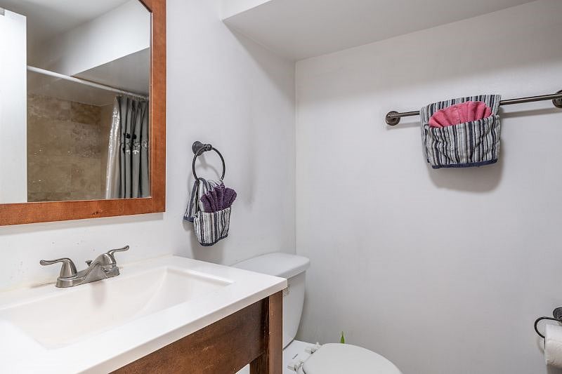 bathroom with toilet, sink, and bath tub and shower