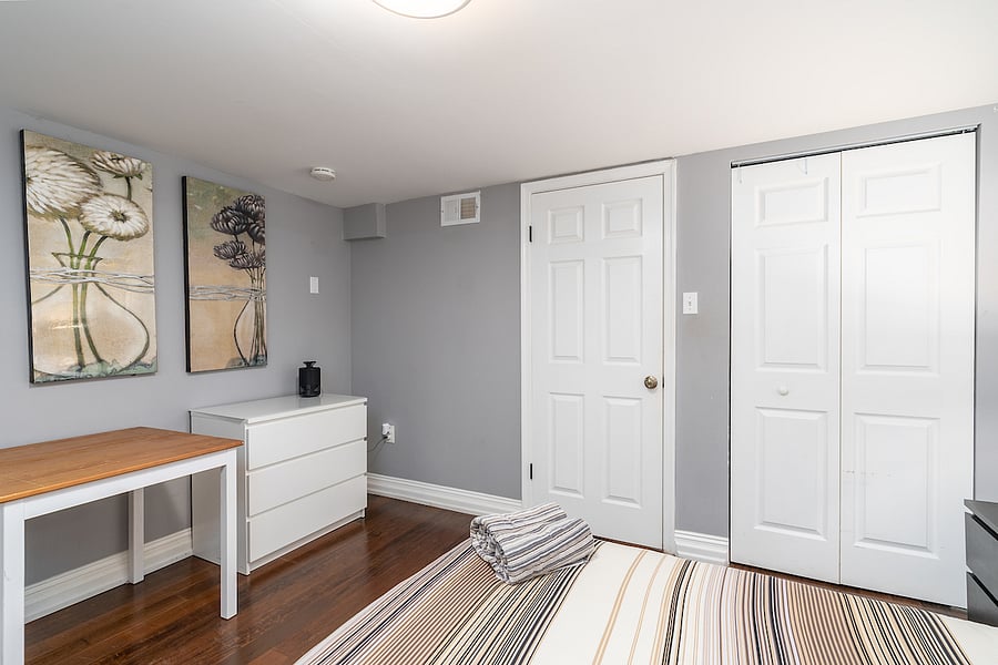 second bedroom with desk, chair, and closet
