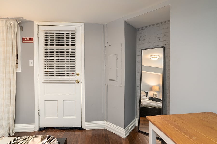 second bedroom with full length mirror. please note that the door is not a back exit.