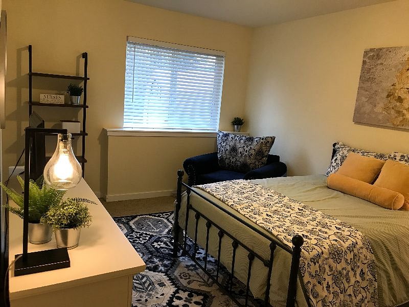 Furnished bedroom in downstairs area of house. High ceilings. Blackout curtains available.