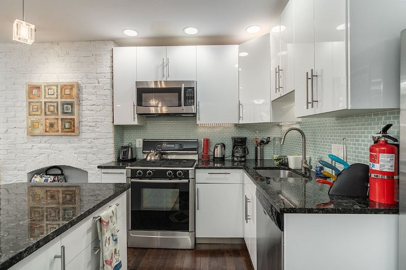 kitchen with stove top, oven dishwasher, microwave, sink, and fridge