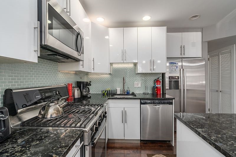 kitchen with stove top, microwave, fridge with water and ice dispenser
