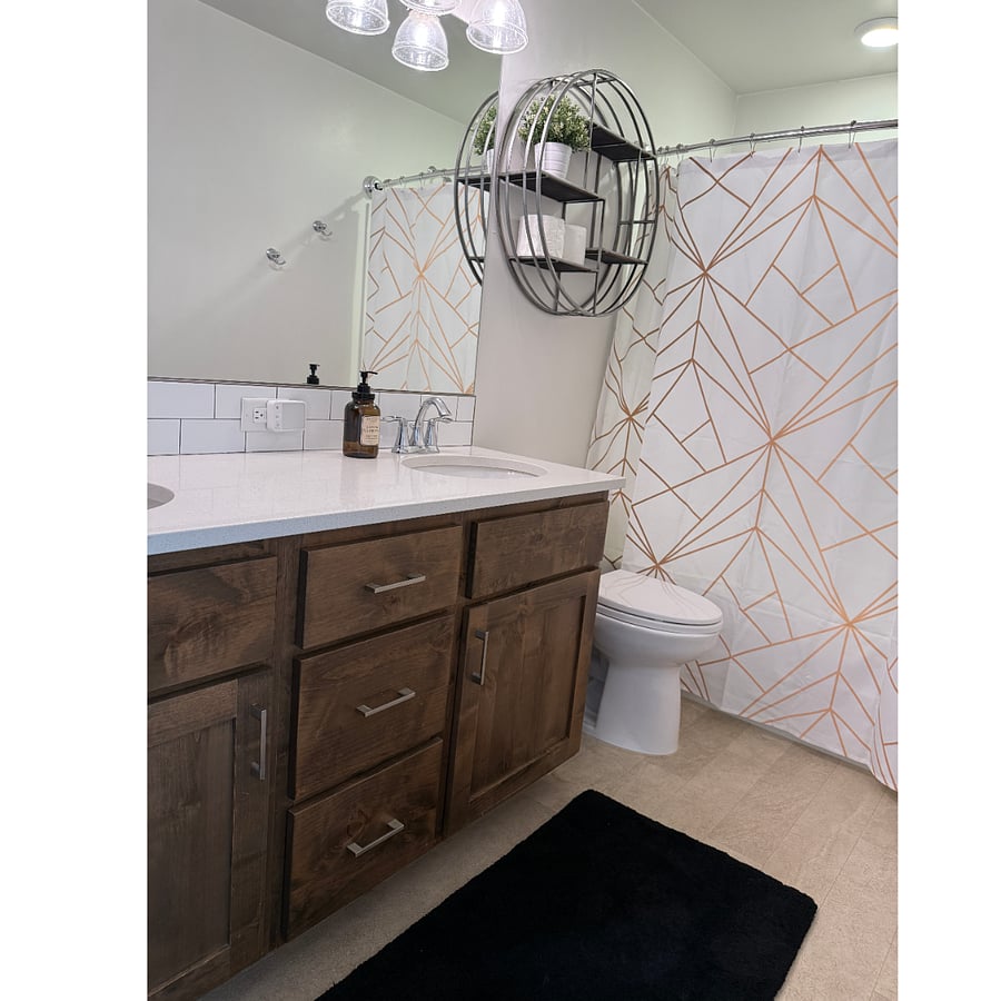 Bathroom has ample storage and sparkling fixtures. 