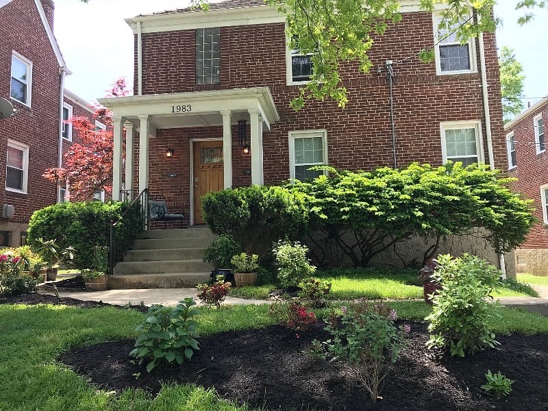 Front of house showing two levels, each with a two bedroom apartment
