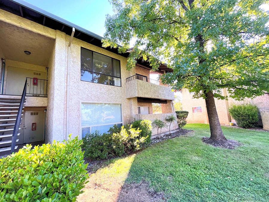 Unit is on the bottom floor with private patio and lovely shade tree protecting area from the heat of afternoon sun.