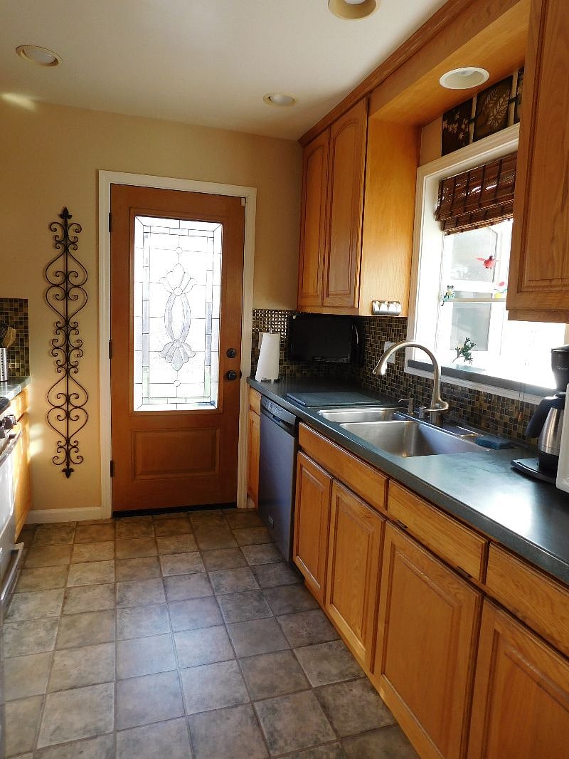 Galley kitchen with gas stove and oven, ice/water dispenser in the refrigerator front, coffee maker, microwave, and all necessary utensils, spices and small appliances.