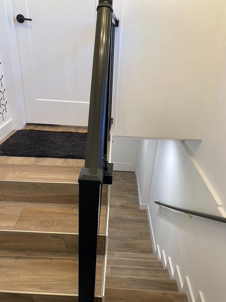 From the side entrance, steps lead up to the main floor and down to the apartment.