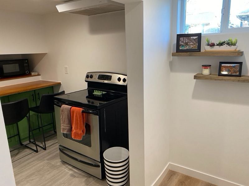 As you reach the end of the hall, the kitchen is on your left