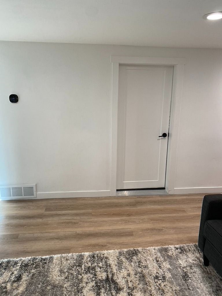 Ecobee thermostat. This is the main door to the apartment (photo taken from in the living room). We've added coat hooks to the right of the thermostat and a bench with shoe storage