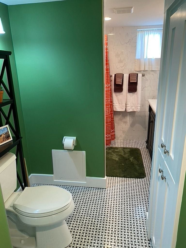 There is a storage closet across from the toilet