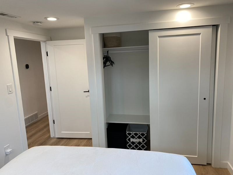 View from inside the room - Closet with storage space and hangers provided.