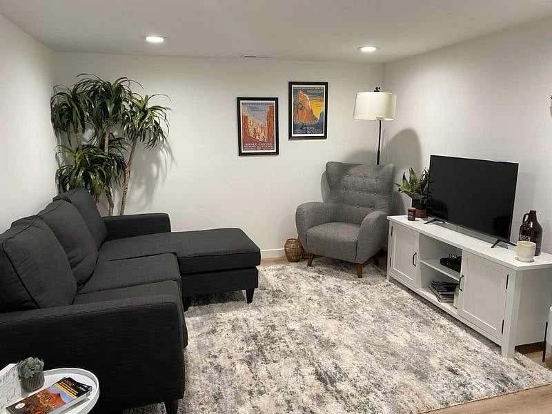 When you enter the apartment, you step into the living area. TV is a smart TV with apps available. There are hallways to the right and left - right leads to larger bedroom and the bathroom, left to the kitchen and other bedroom