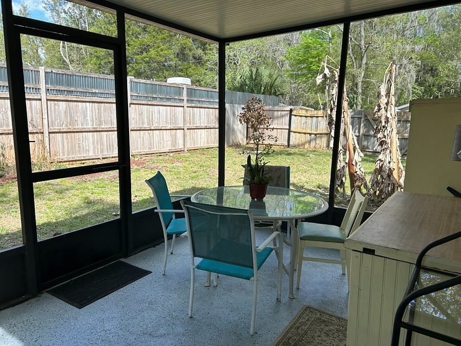 Screen porch with tall privacy fence