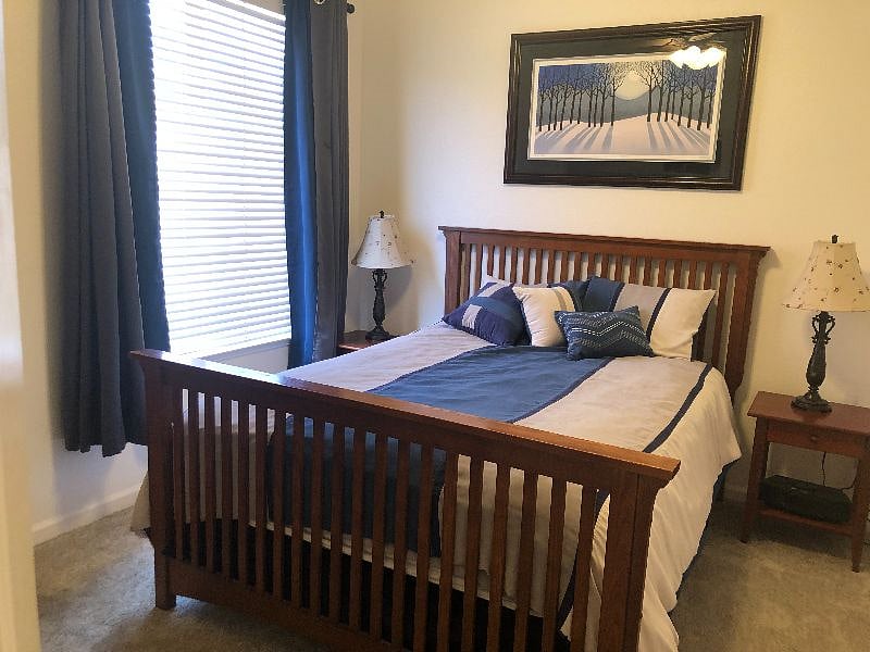 Furnished bedroom with queen bed